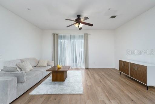 living room featuring ceiling fan and light wood-type flooring