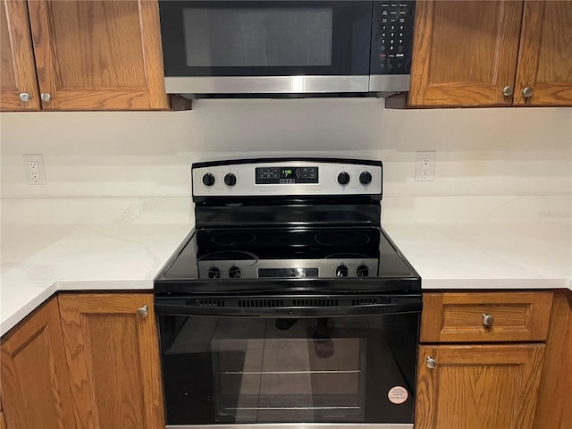 kitchen featuring black range with electric stovetop