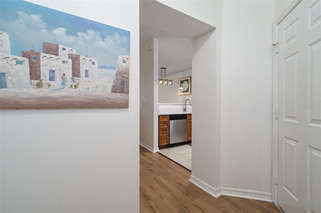 hallway with light hardwood / wood-style flooring