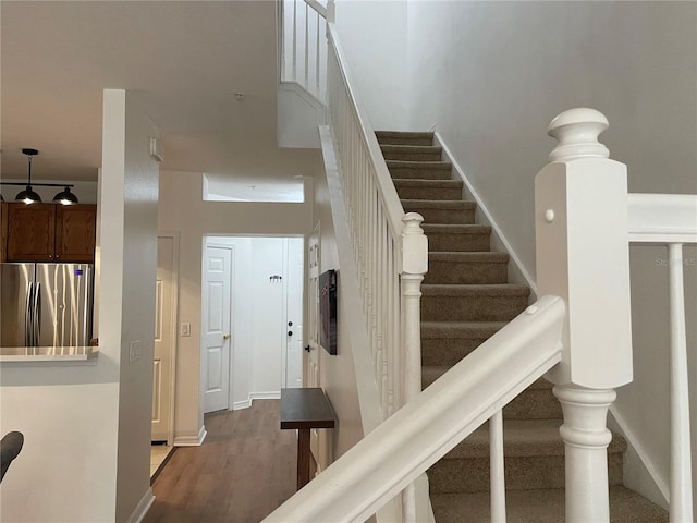 staircase with hardwood / wood-style floors