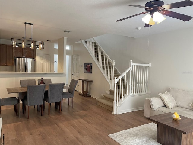 dining area with hardwood / wood-style floors and ceiling fan