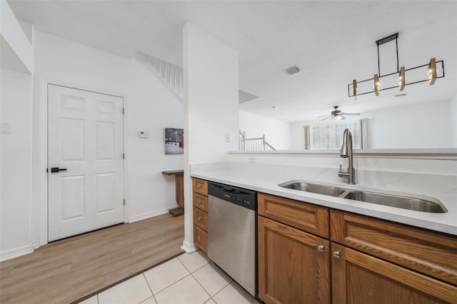 kitchen featuring light tile patterned flooring, decorative light fixtures, sink, stainless steel dishwasher, and ceiling fan