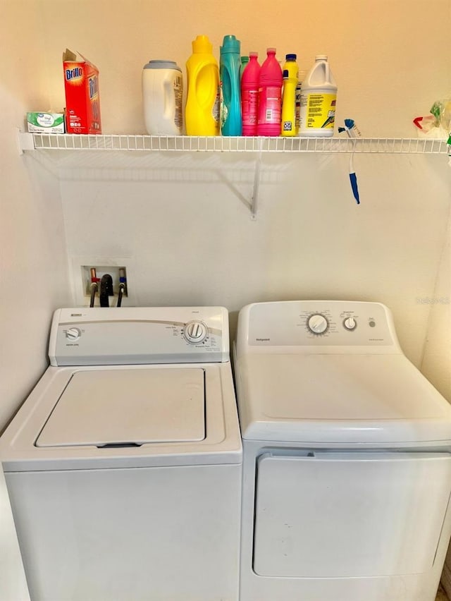 clothes washing area with washing machine and dryer