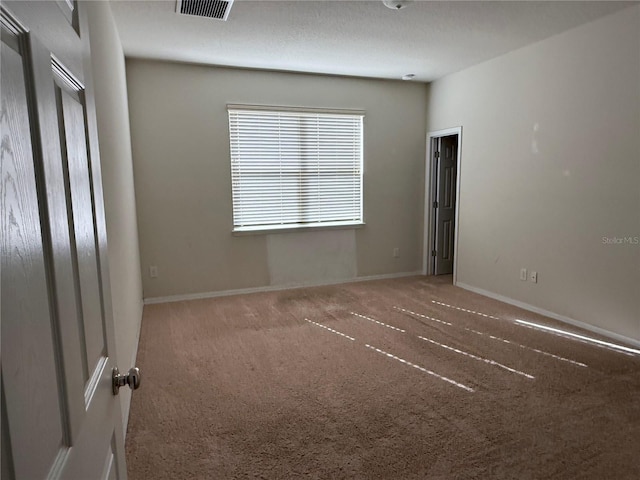 spare room featuring carpet floors