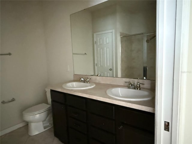 bathroom with tile patterned flooring, a shower, vanity, and toilet