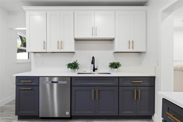 kitchen featuring gray cabinetry, dark wood-type flooring, sink, dishwasher, and white cabinetry