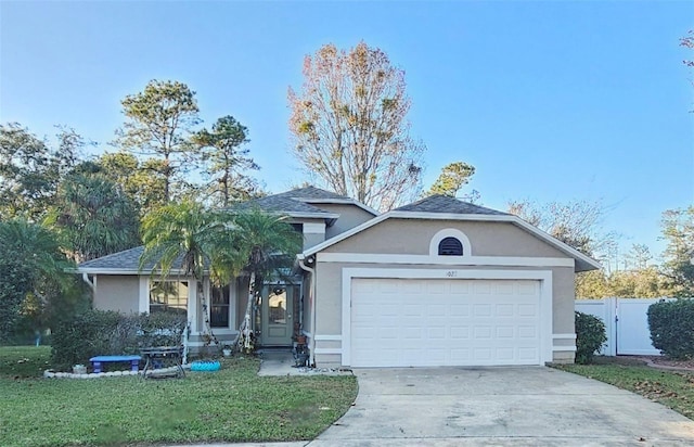 view of front of house with a front lawn and a garage