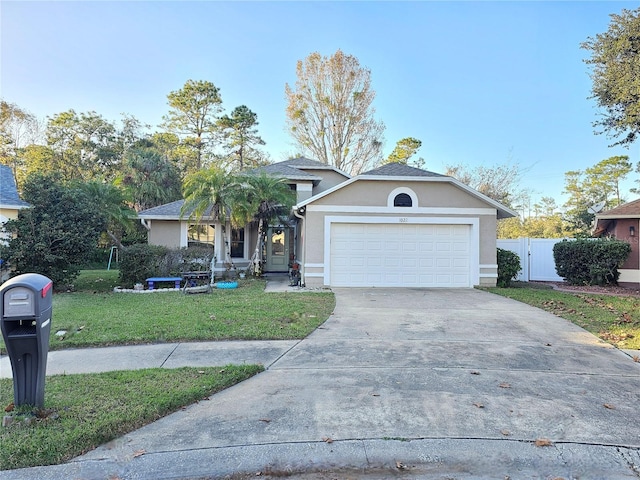 view of front facade with a garage and a front lawn