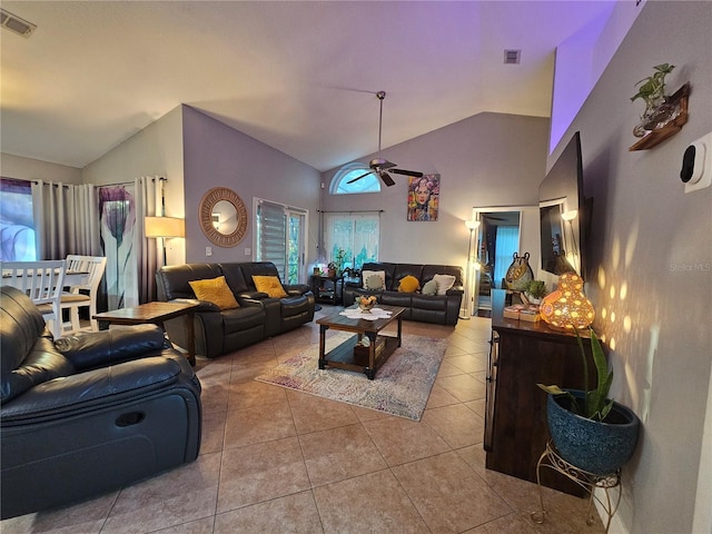 tiled living room featuring ceiling fan and high vaulted ceiling