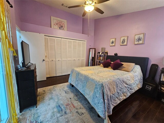 bedroom with ceiling fan, a closet, and dark wood-type flooring