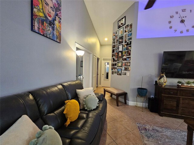 tiled living room featuring high vaulted ceiling