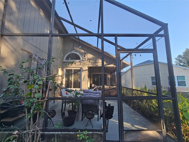 view of patio with glass enclosure