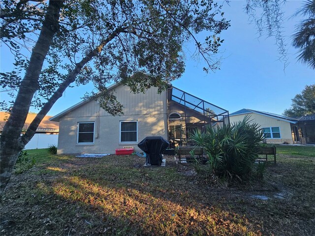 back of property with a lawn