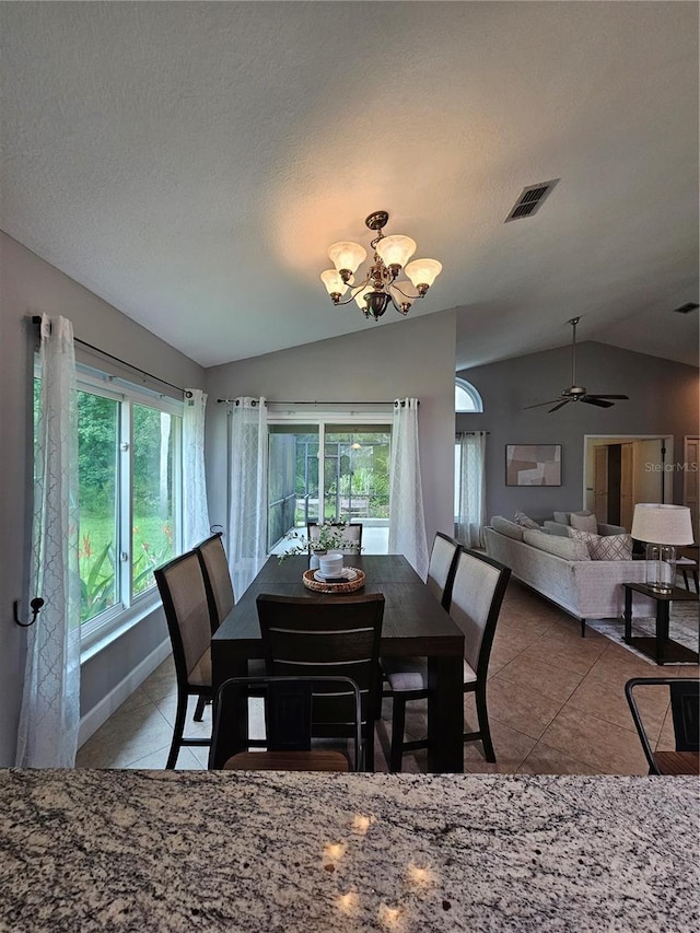 1022 Bartlett Ct, Oviedo, FL 32765 - dining room featuring vaulted ceiling, tile patterned flooring, a chandelier, ceiling fan, and a textured ceiling