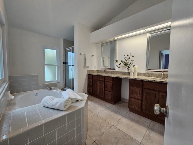 1022 Bartlett Ct, Oviedo, FL 32765 - full bathroom featuring a shower stall, double vanity, a garden tub, and vaulted ceiling