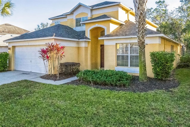 view of front facade with a garage and a front yard