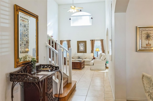 tiled foyer with ceiling fan