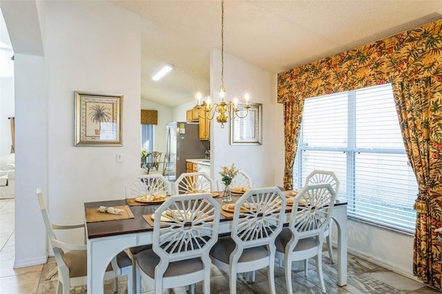 dining room featuring light tile patterned floors, lofted ceiling, an inviting chandelier, and a healthy amount of sunlight