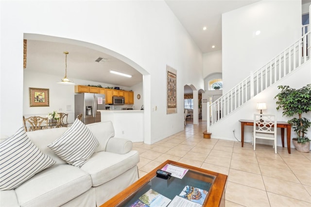 tiled living room with a towering ceiling