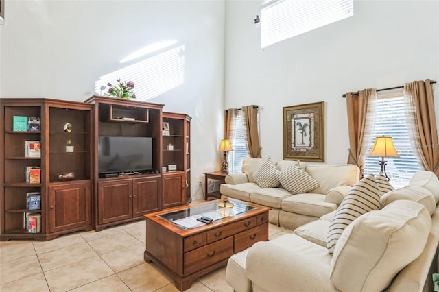 living room featuring light tile patterned floors and a high ceiling