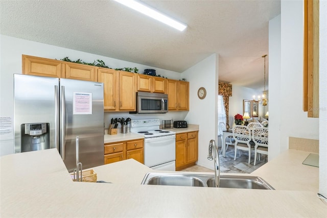 kitchen with sink, hanging light fixtures, stainless steel appliances, a chandelier, and a textured ceiling