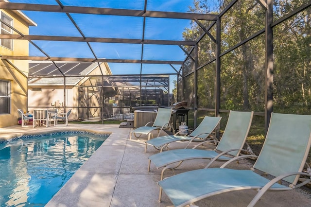 view of pool featuring a lanai, a patio, and a hot tub