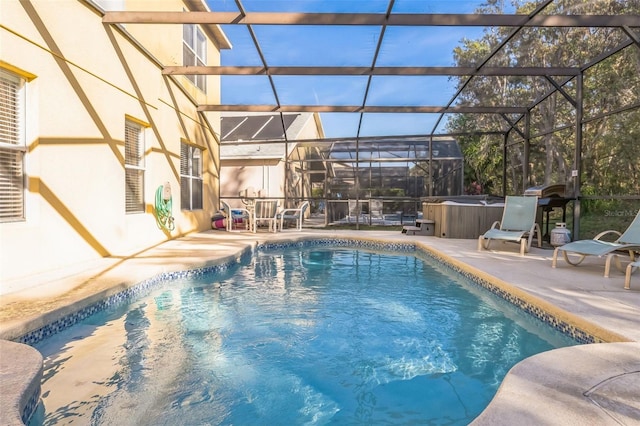 view of pool featuring a hot tub, a lanai, and a patio area