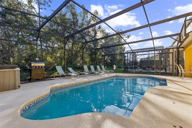 view of swimming pool featuring area for grilling, a lanai, and a patio area