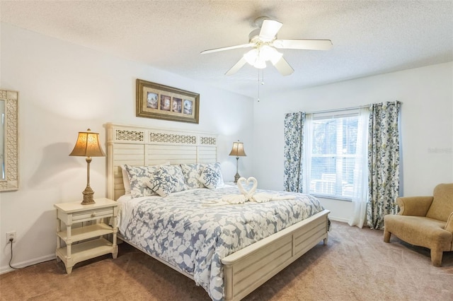 bedroom with ceiling fan, light colored carpet, and a textured ceiling