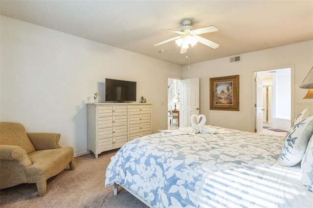 bedroom featuring light carpet, connected bathroom, and ceiling fan