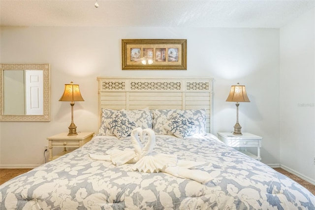 bedroom with carpet floors and a textured ceiling