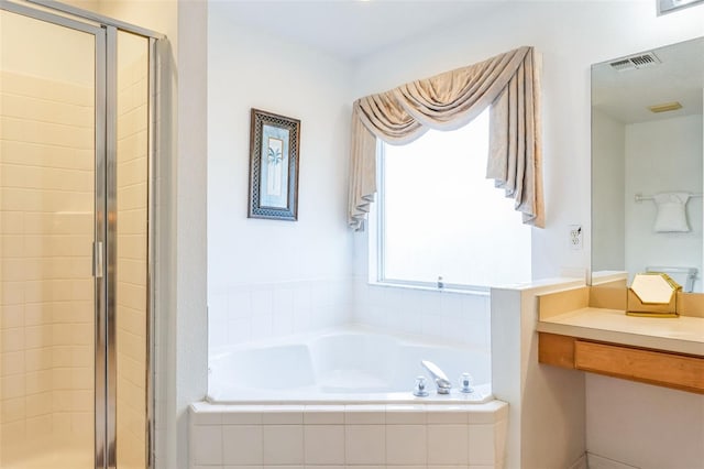 bathroom featuring shower with separate bathtub