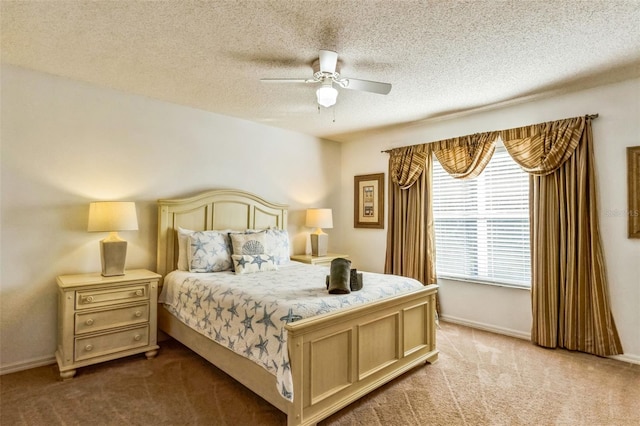 carpeted bedroom featuring ceiling fan and a textured ceiling