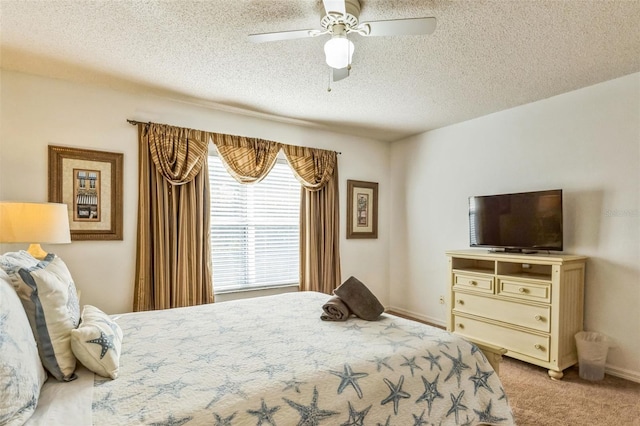 carpeted bedroom featuring a textured ceiling and ceiling fan