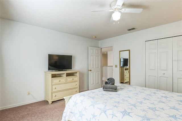 carpeted bedroom featuring a closet and ceiling fan