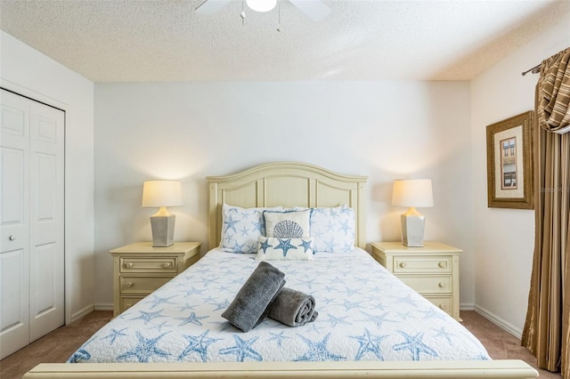 carpeted bedroom with ceiling fan, a closet, and a textured ceiling