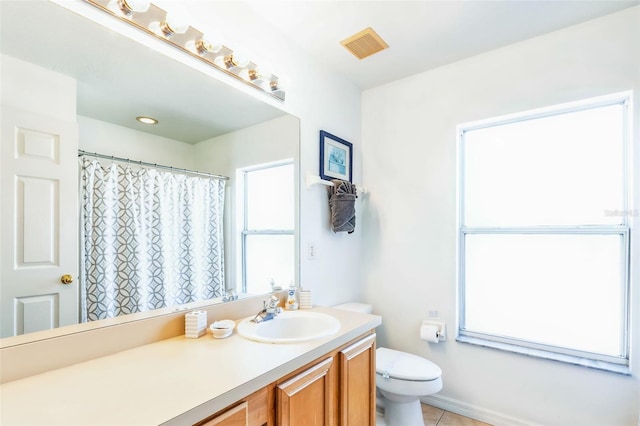 bathroom featuring tile patterned flooring, vanity, and toilet