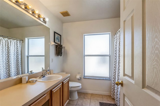 bathroom featuring tile patterned flooring, vanity, and a wealth of natural light