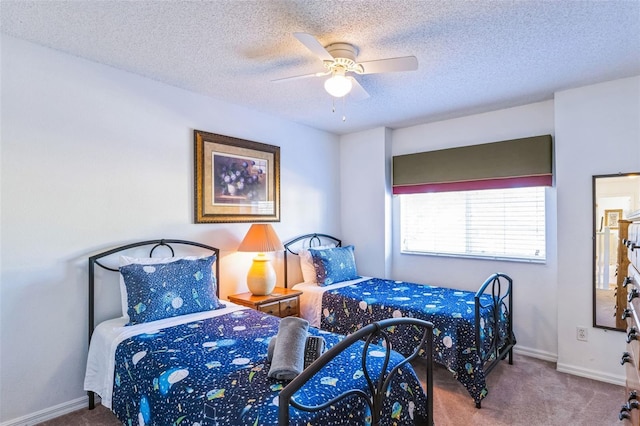 carpeted bedroom featuring a textured ceiling and ceiling fan