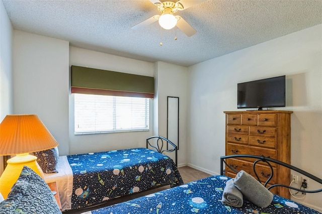 carpeted bedroom with a textured ceiling and ceiling fan