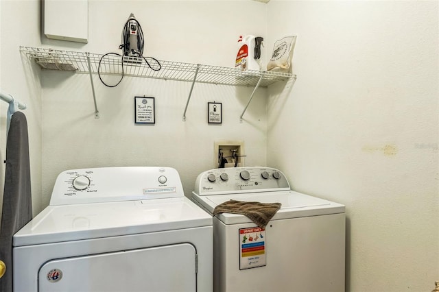 washroom with washing machine and clothes dryer