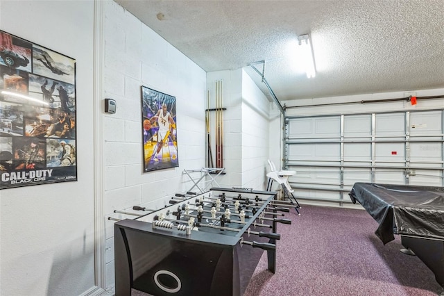 playroom with a textured ceiling, carpet floors, and pool table