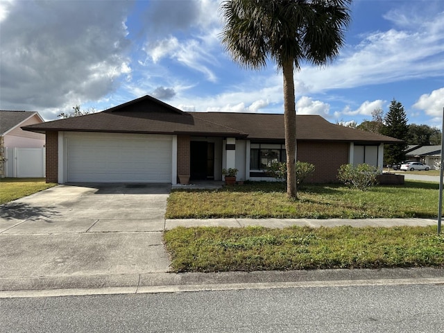 single story home with a garage and a front yard