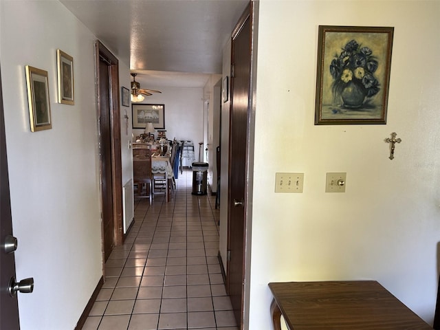 hall featuring dark tile patterned flooring