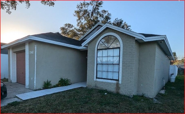 property exterior at dusk featuring a garage