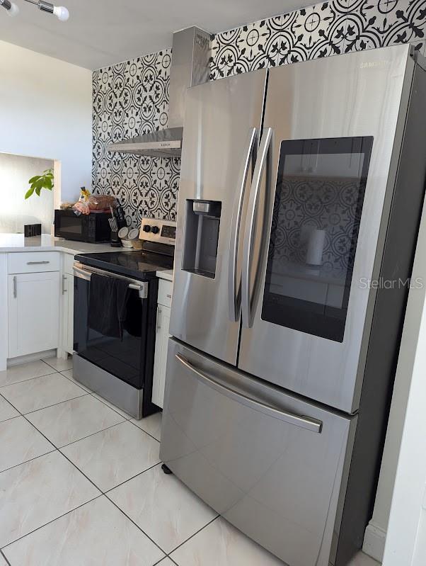 kitchen featuring white cabinets and appliances with stainless steel finishes