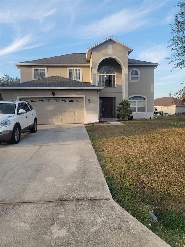 front facade with a garage and a front lawn