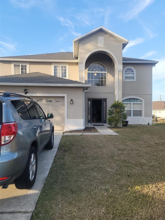 view of front of property with a garage and a front lawn