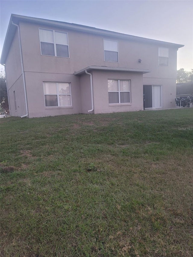 rear view of house with a lawn