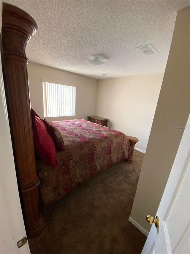 carpeted bedroom with a textured ceiling